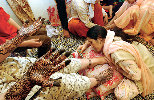 Photo by Ami Vitale | Srinagar, Kashmir, India | 2003 | A bride-to-be is decorated with henna at her engagement ceremony.
