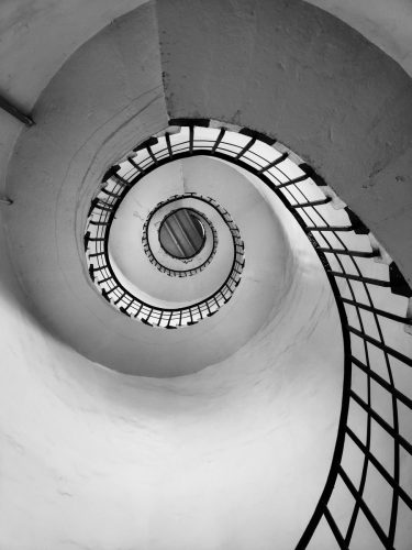 white spiral staircase with black metal railings